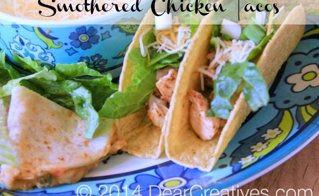 Smothered Chicken tacos and quesadillas on a platter with shredded cheese_