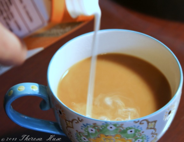 Creamer being poured into coffee in cup, coffee in cup with cream Theresa Huse 2013 -0706