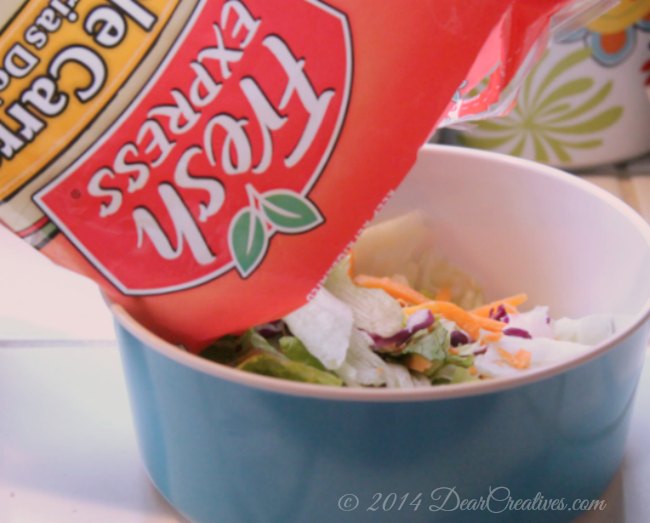 Fresh Express salad being poured into a bowl_