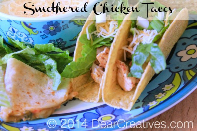 Chicken Tacos Smothered Chicken tacos and quesadillas on a platter with shredded cheese_