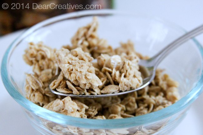 bowl of granola and granola on a spoon_