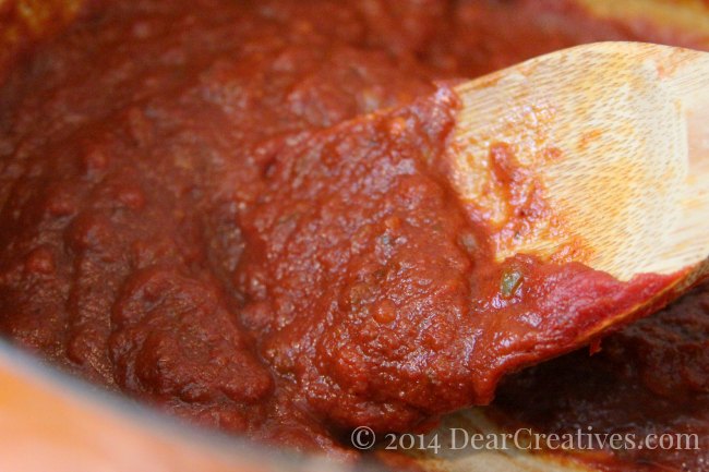 Homemade barbecue sauce in a pot being stirred_