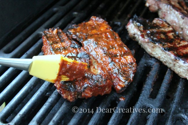 brushig grilled meat with a silicone pastry brush