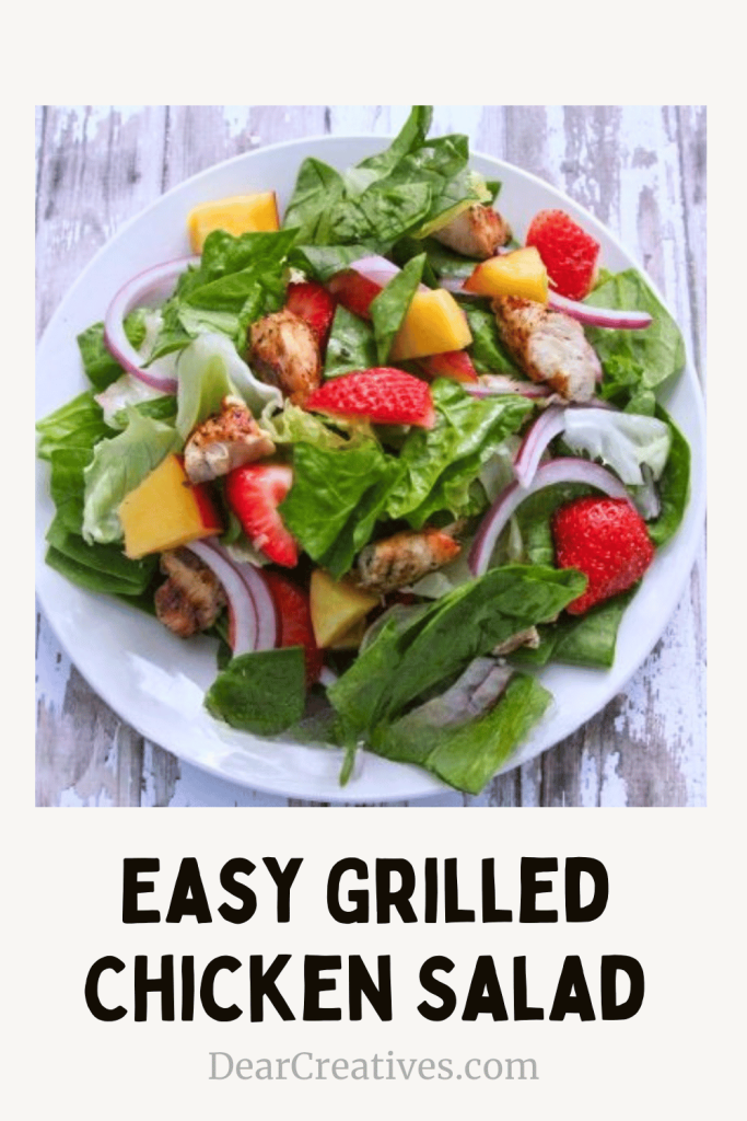 Easy grilled chicken salad recipe with strawberries, lettuce, and homemade ginger dressing on a plate
