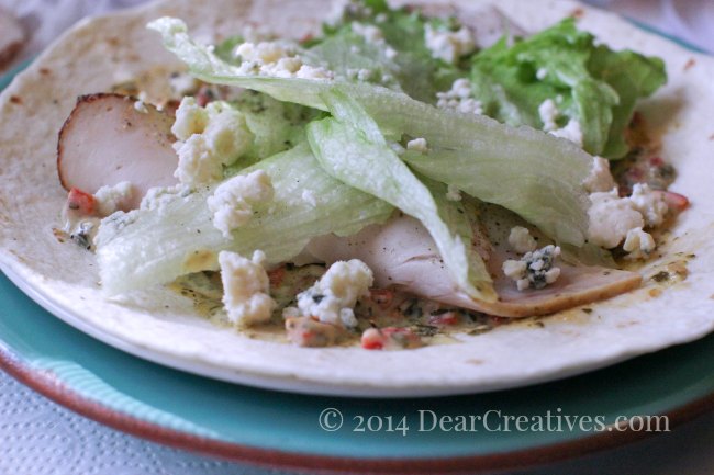 Turkey wrap sandwich with blue cheese crumbles ready to be wrapped_© 2014 DearCreatives.com