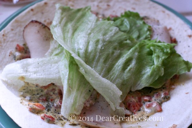 Turkey wrap sandwich with pesto roasted red pepper spread_