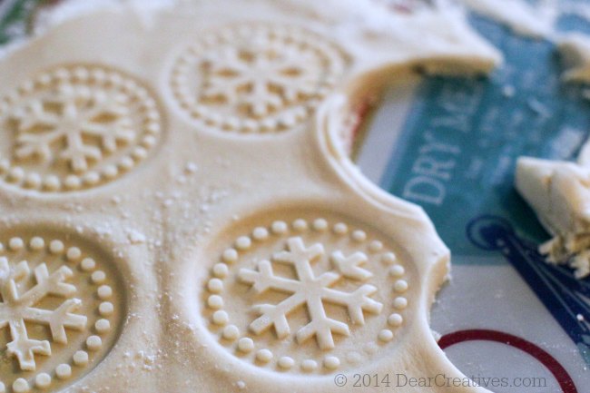 Rolled out cookie dough with snowflakes press into the dough_© 2014 Theresa Huse 2014_ DearCreatives.com