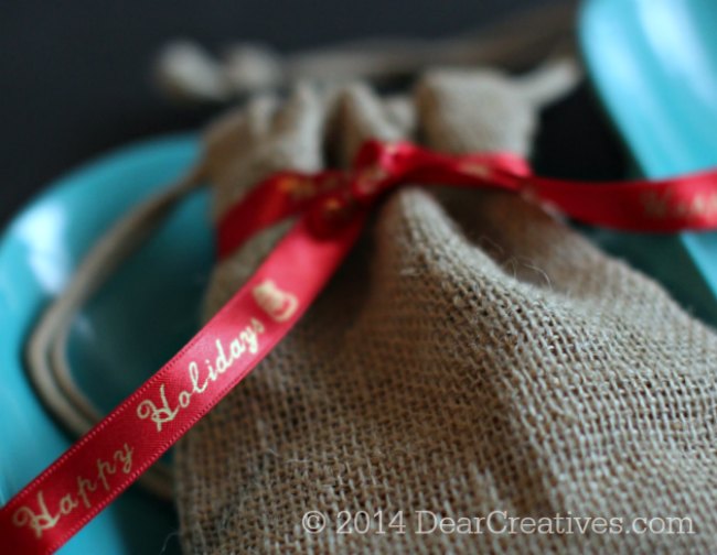 red ribbon printed with gold letters tied around a burlap bag_Epson LabelWorks printed Ribbon_© 2014 DearCreatives.com