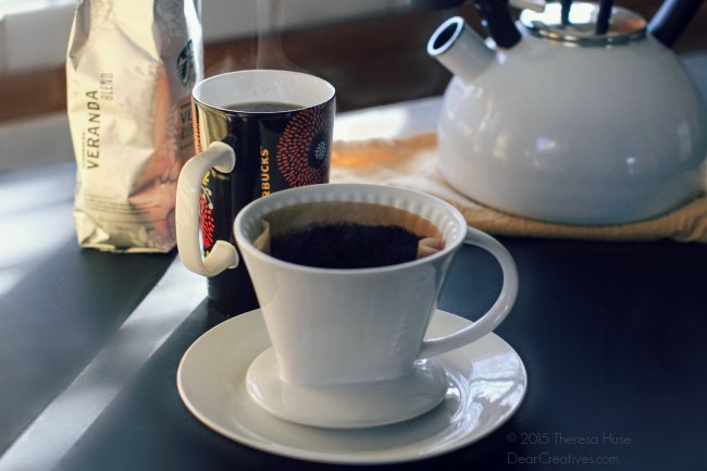 Fresh Brewed Coffee in a cup and a water kettle- coffee beans and pour method brewer