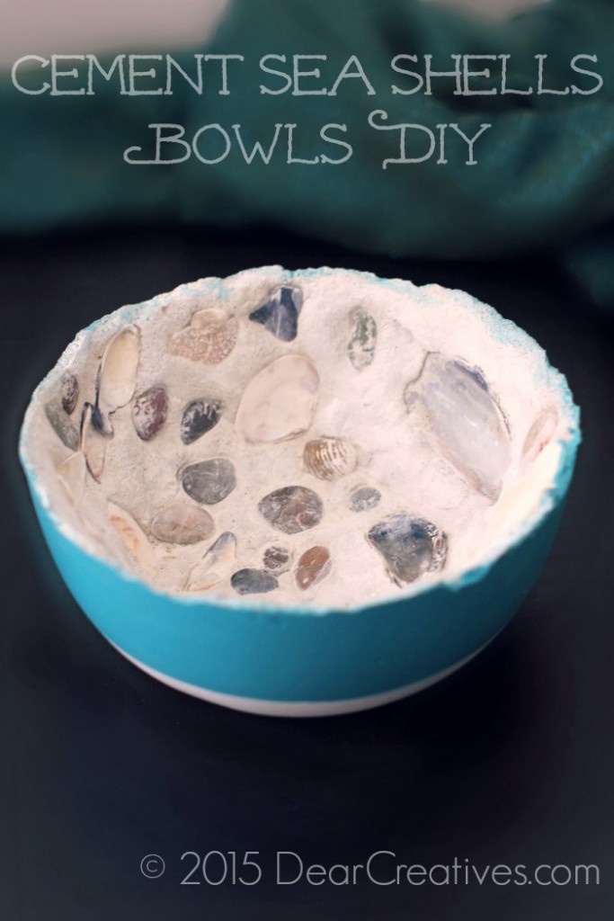 close up of a finished DIY concrete bowls with seashells inside and painted turquoise on the outside