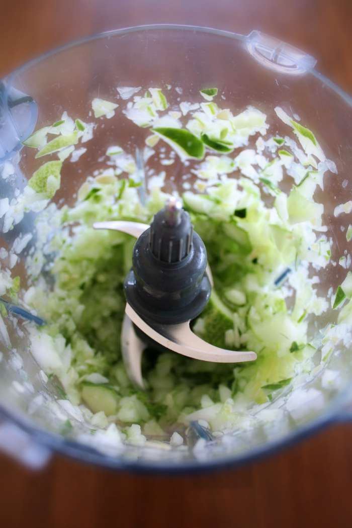 Chopping up onion and cucumber in the food processor for sweet pickle relish