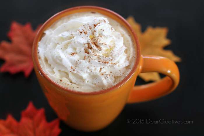 Pumpkin spice latter in a cup with whip cream and cinnamon