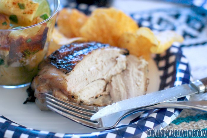 Grilled Chicken Chicken Thigh close up on a plate with sweet potato salad and chips