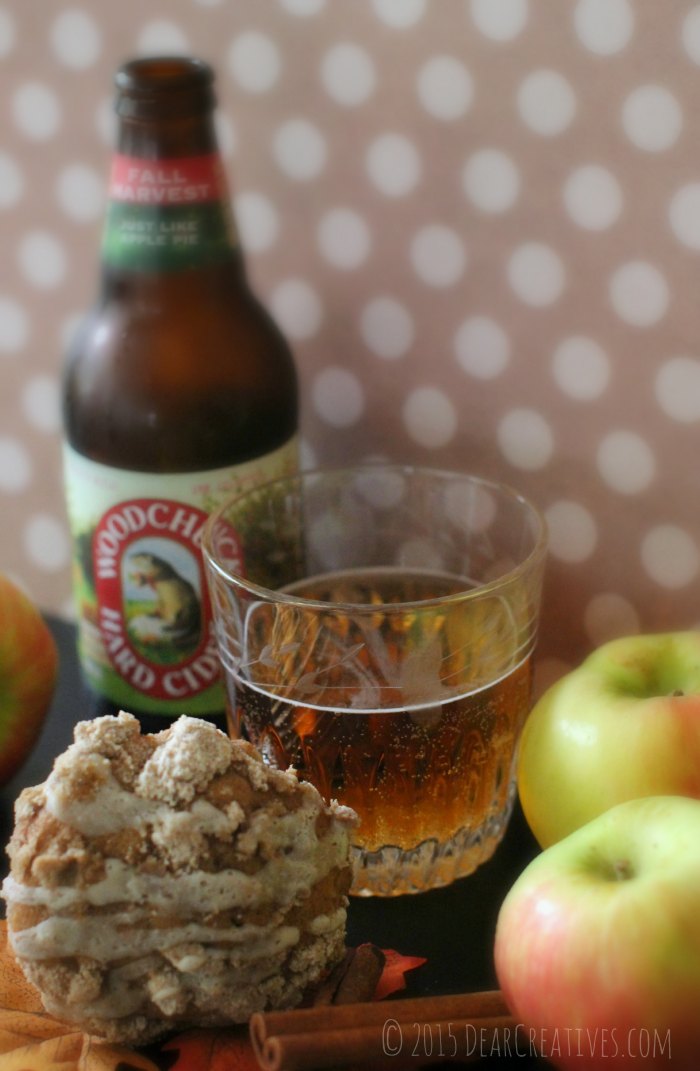 WoodChuck Hard Cider in a glass next to an apple muffin