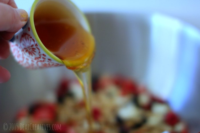 Pouring honey into a bowl for granola