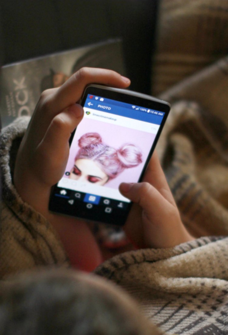 Family Mobile Looking over teen to see what they are viewing on cell phone