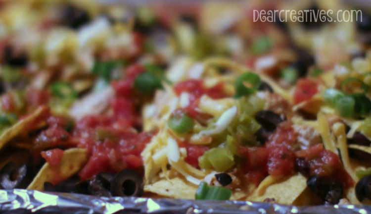 Easy Recipe loading up nachos onto a baking sheet