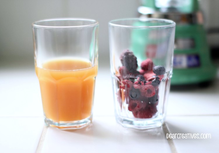 Drink Recipes |Berry Smoothie Recipe | Two Glasses one with apple juice one with frozen berries ready to add to blender
