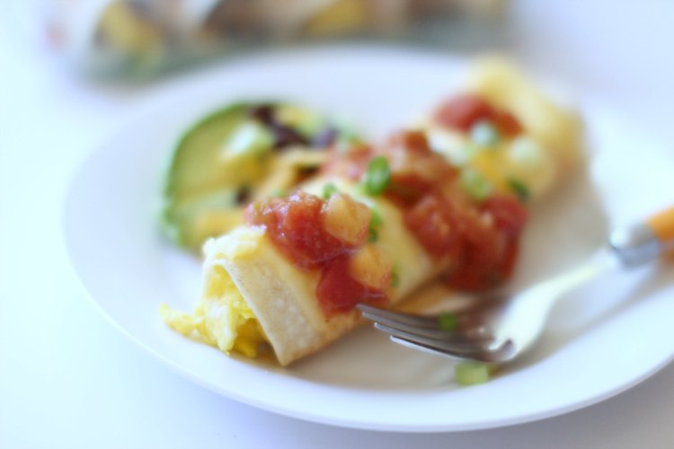 Sweet and Spicy Easy Make Ahead Enchilada Recipe. Perfect for breakfast, brunch or dinner. Made with Eggs, Black beans, Cheese, Avocado, Salsa, Green Onion