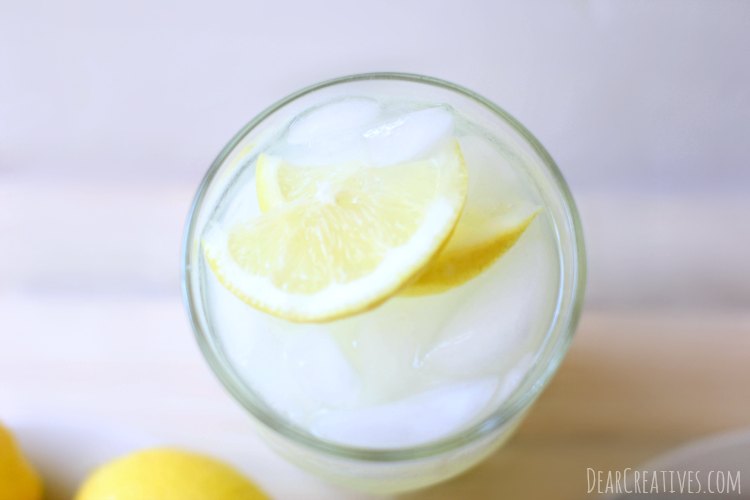 lemons sliced lemons in a glass of lemonade