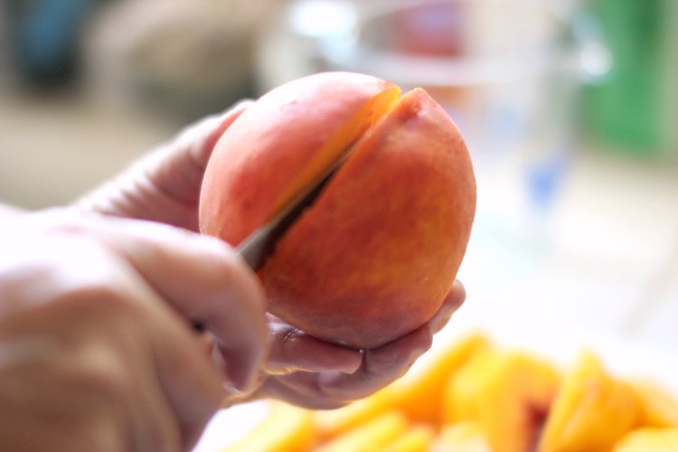  How to cut a peach for peach pie, cobbler and desserts How To Cut A Peach start by cutting down and around the center of the peach and cut it in half and then into quarters