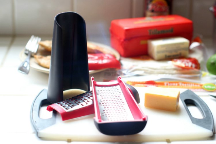 in the kithen- kitchen tools-cooking T-fal cheese grater on a cutting board with cheese © 2017 Theresa Huse dearcreatives.com 