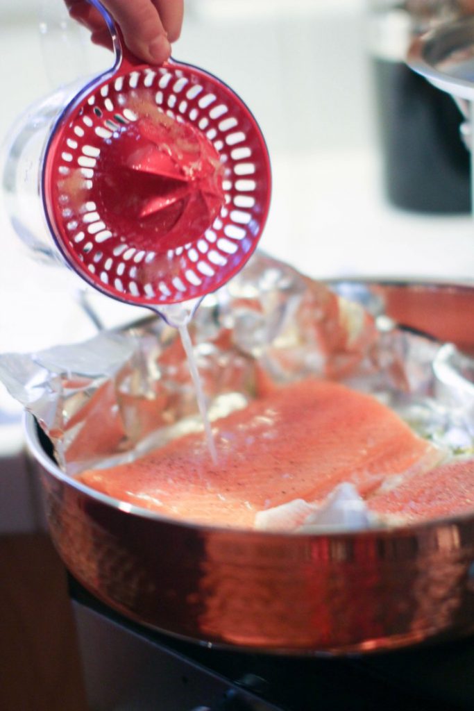 in the kithen- kitchen tools-cooking pouring lemon juice on salmon from T-fal citrus juicer © 2017 Theresa Huse