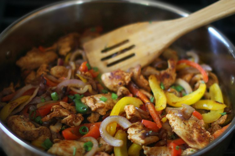 Review Sun Basket Meal Kit Delivery Review DearCreatives.com chicken fajitas being cooked in a skillet from the Sun Basket meal kit and recipe.