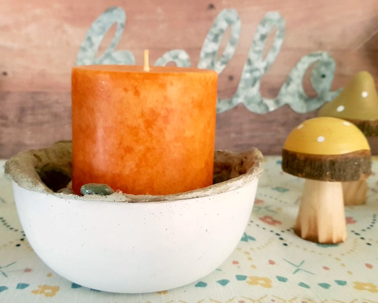 pumpkin candle in a home made cement candle holder