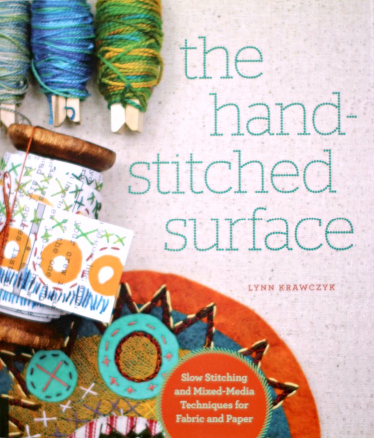 Hand stitching in art journaling with fabric and paper