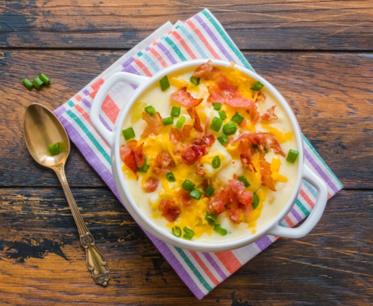 Potato soup with garnishes of cheddar cheese, diced green onions, and bacon. Easy 30 minute recipe. #soup #potatosoup #loadedpotatosoup DearCreatives.com