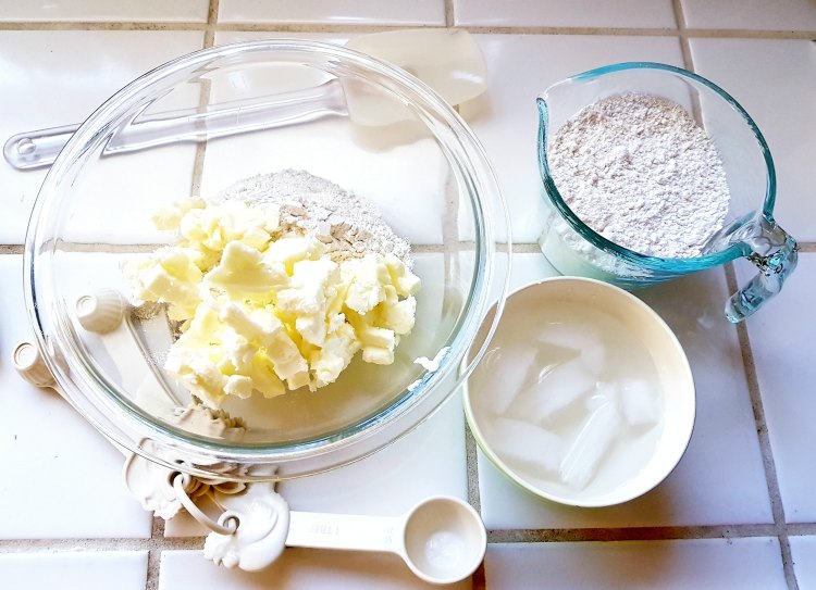 making apple hand pies pie crust cold butter, flour, ice cubes in bowls making pie crust for apple pies