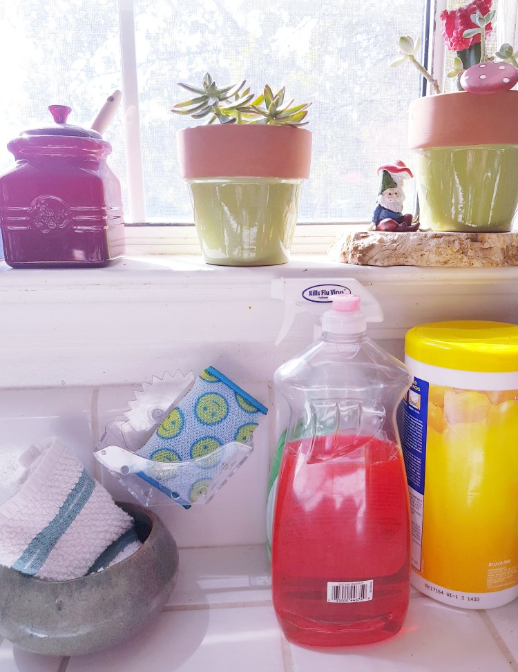 kitchen counter with cleaning supplies ready for cleaning the kitchen DIY cleaning tips DearCreatives.com