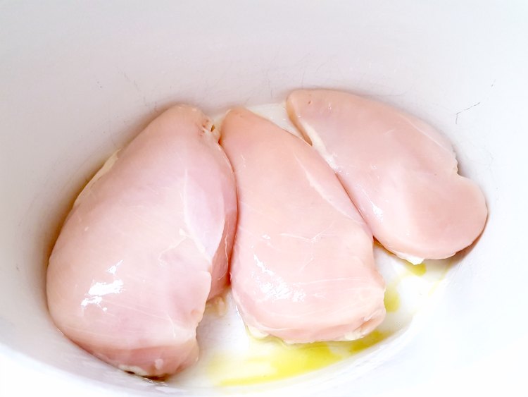 chicken breasts in the bottom of a crockpot for a soup