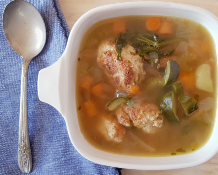 chicken meatball soup in a bowl with a spoon and napkin. soup recipe at DearCreatives.com