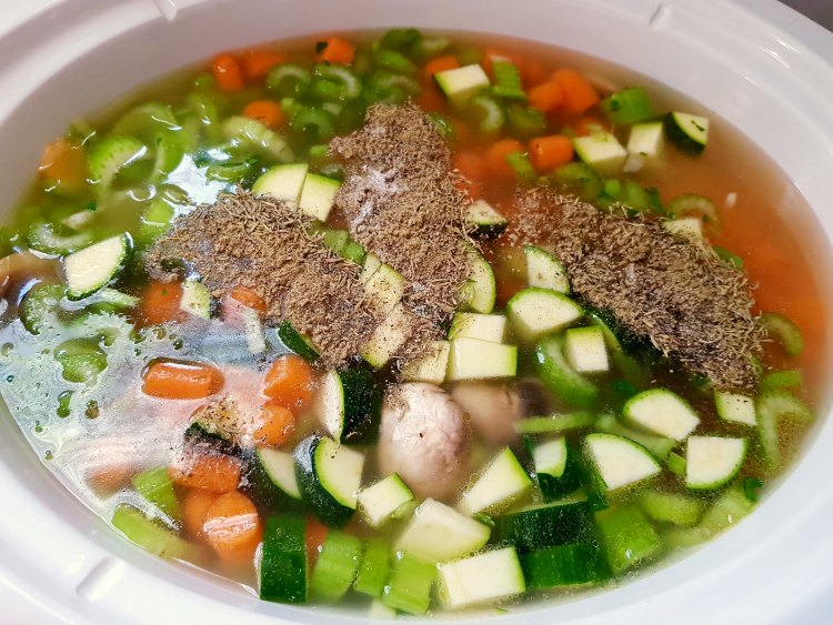 chicken vegetable soup with spices on top to be stirred in before lidding and cooking 