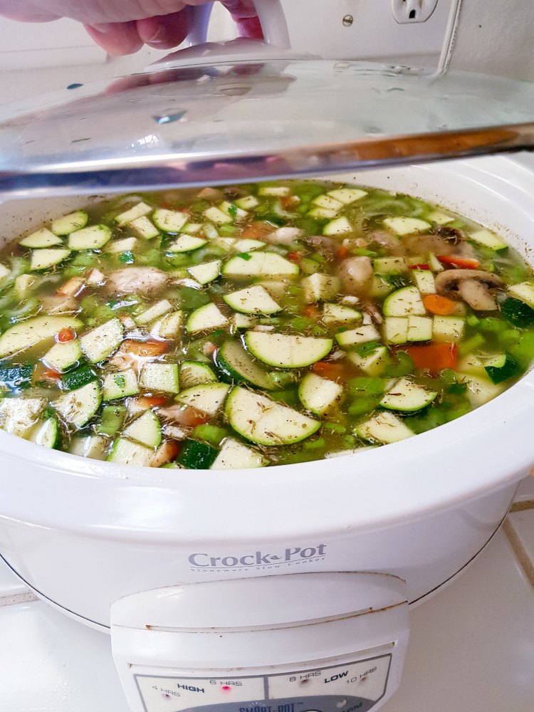 lidding the crockpot for the chicken vegetable crockpot soup