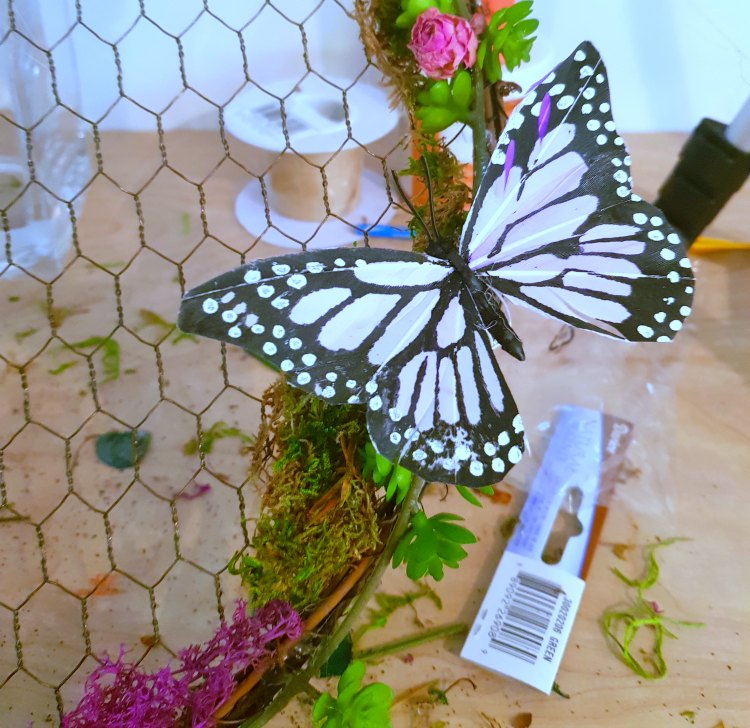 Adding butterflies to a succulent wreath. DearCreatives.com