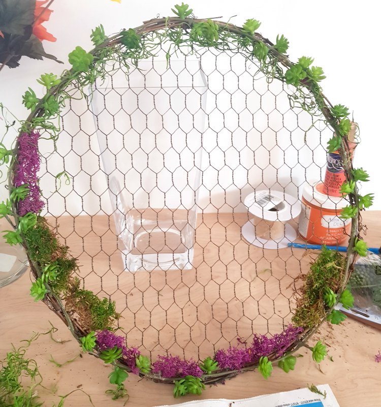 Adding moss to the succulent wrath. See this wreath idea, and diy wreath at DearCreatives.com