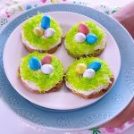 Holding a plate of decorated Easter Cookies that are so easy to make. This will make you love decorating Easter cookies, it's a no fail easy recipe. Grab it at DearCreatives.com