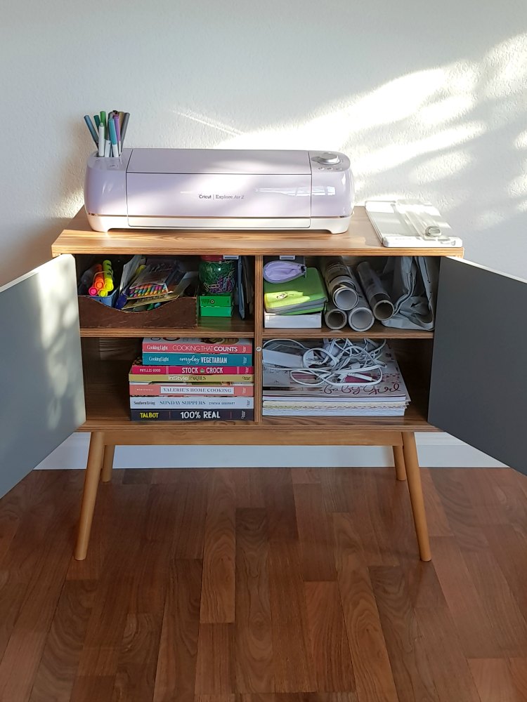 Inside storage of Oslo Table Console storage cabinet. Filled with office supplies, cooking books, and craft supplies. DearCreatives.com