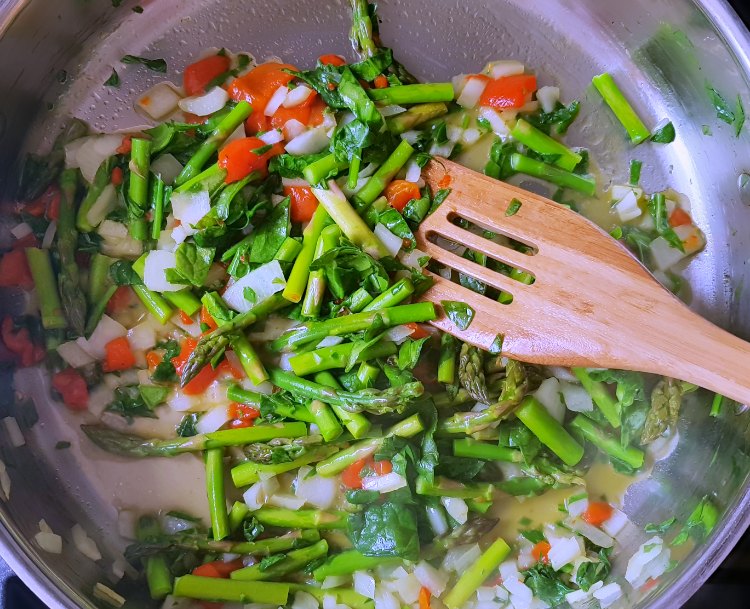 asparagus, onion, spinach, roasted red bell pepper in a copper bottom skillet sauteing for a quiche. Recipe at DearCreatives.com