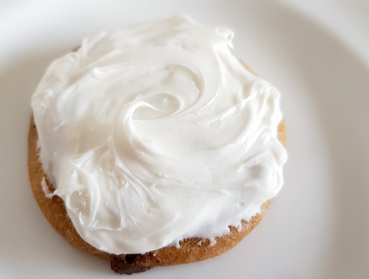 chocolate chip cookie with white frosting being decorated for Easter Cookies © 2018 DearCreativves.com