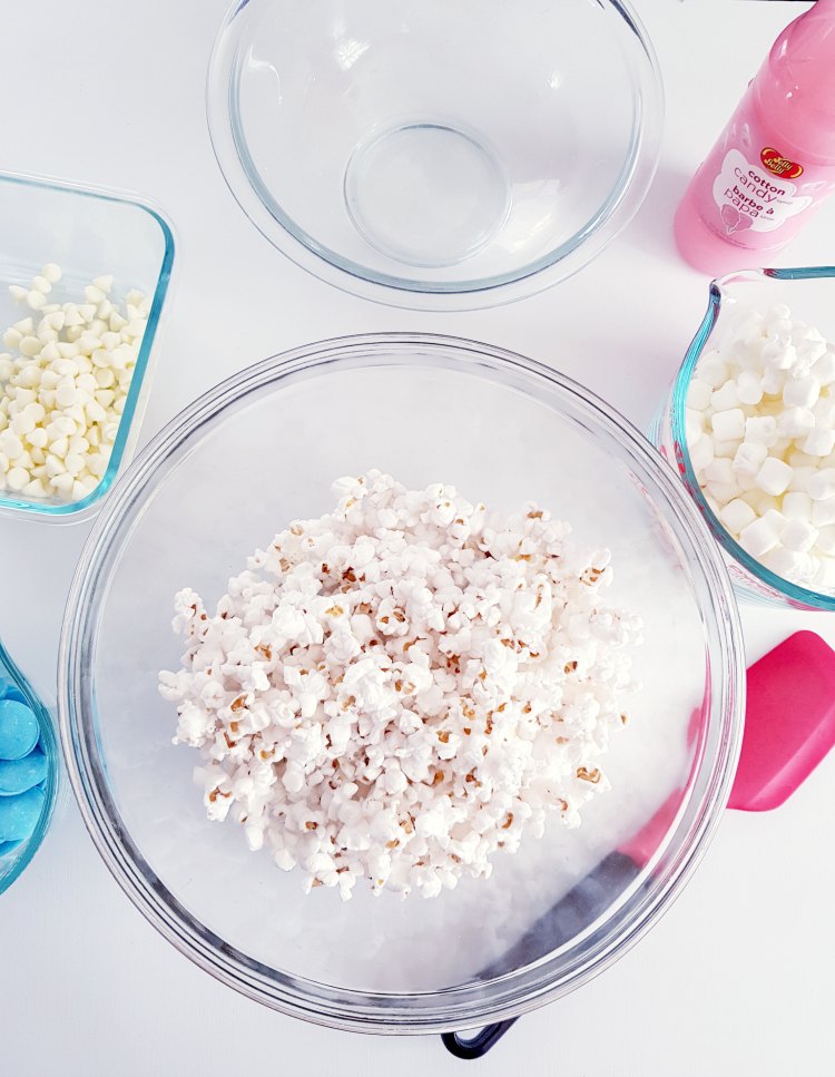 first step put measured pop corn into bowl, and then melt marshmallows DearCreatives.com