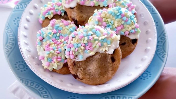 white chocolate dipped cookies on a plate with seasonal sprinkles for spring celebrations. See how to make this, and adapt the recipe for other seasons.