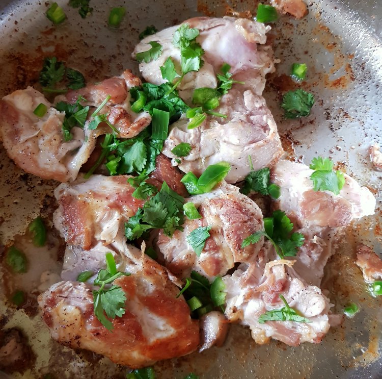 Next adding cilantro, and jalapeno to chicken for the easy chicken recipe