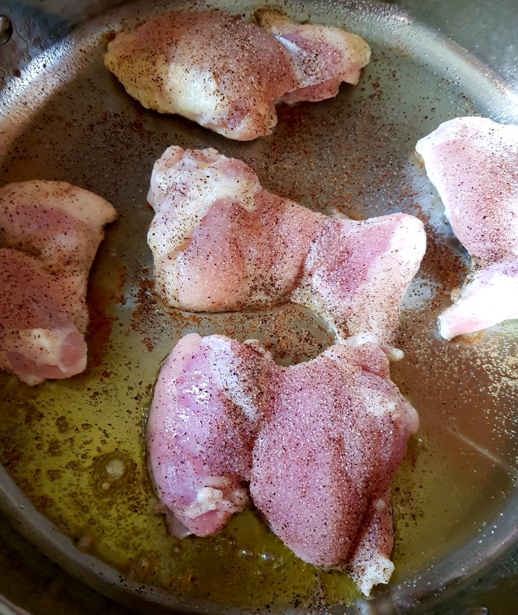 chicken cooking in olive oil with spices for a chicken lime recipe