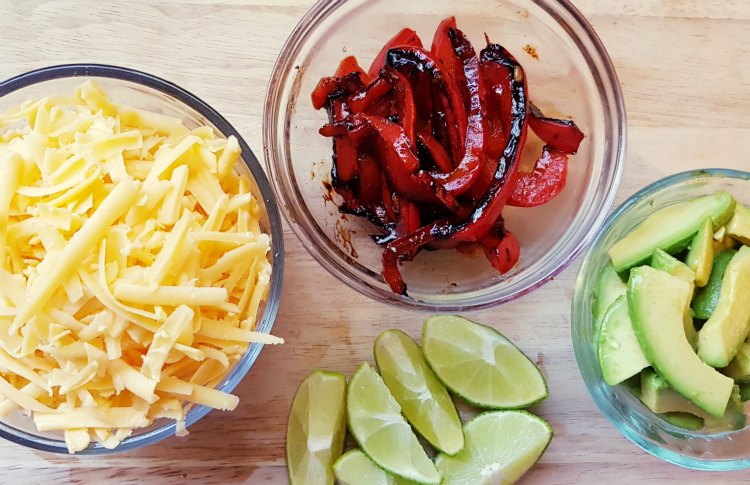 toppings for chicken fajitas tacos or burritos. shredded cheese, avocados, roasted red bell peppers, limes. DearCreatives.com