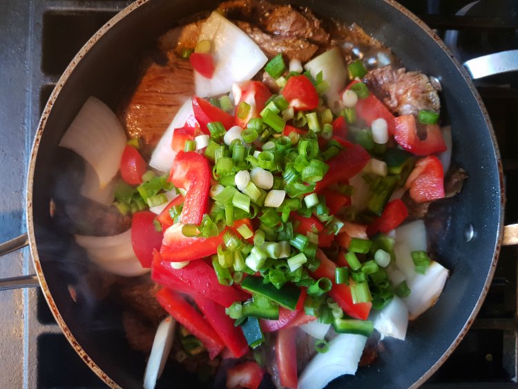 cooking beef stir fry with vegetables in a pan on the stove DearCreatives.com