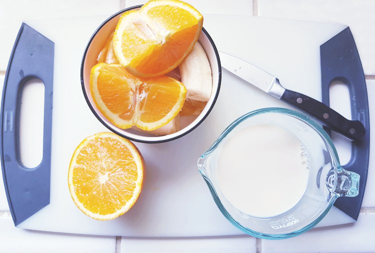 ingredients for an orange Julius smoothie on a cutting board DearCreatives.com